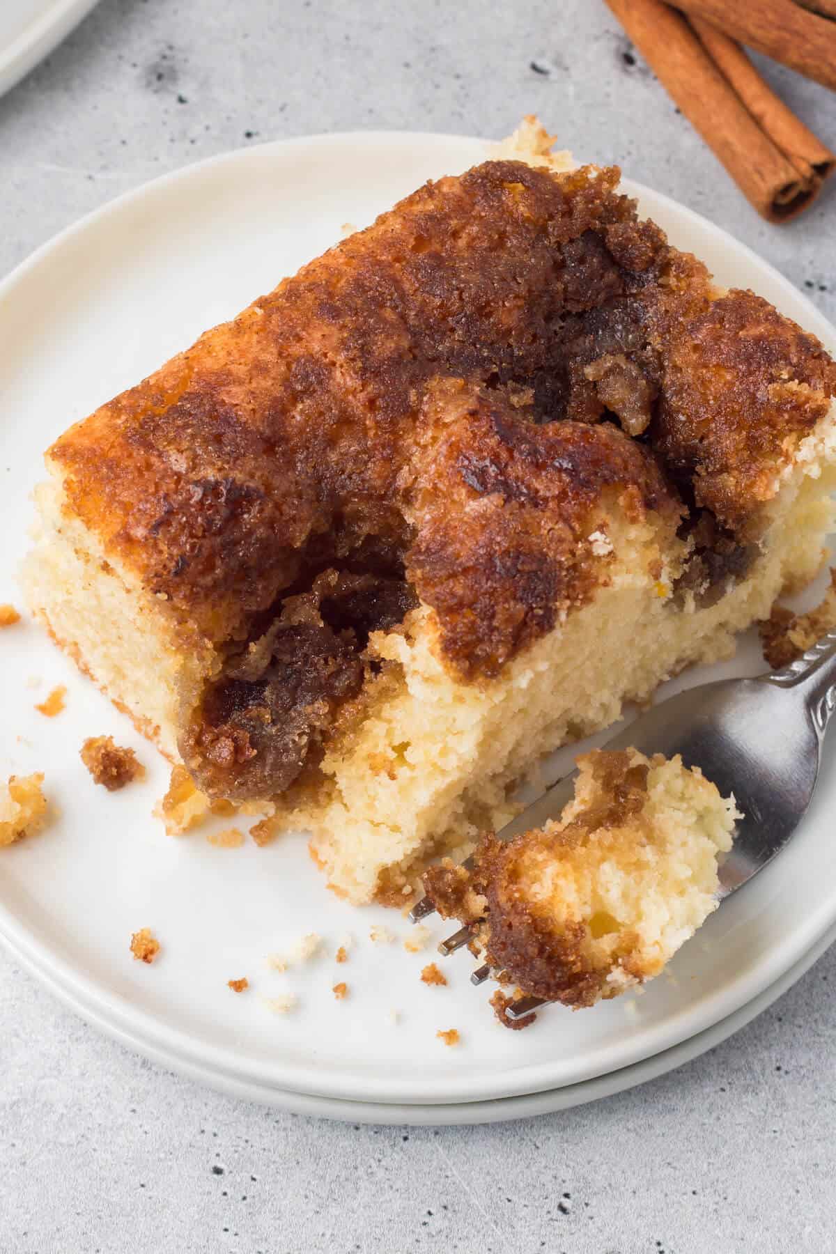 Cinnamon coffee cake on a plate with a fork.