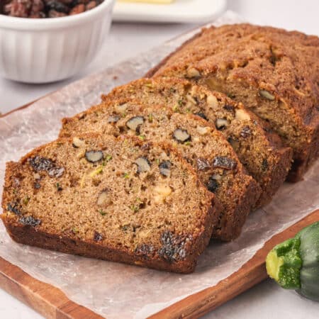 Slices of zucchini bread on a cutting board.