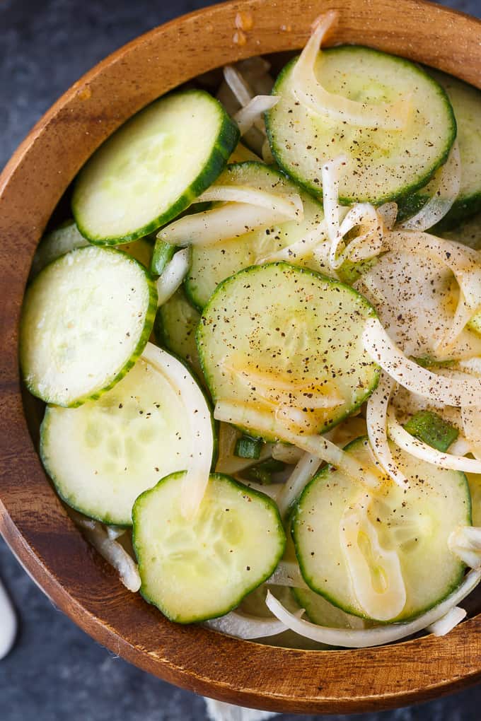 Cucumber Salad - Fresh, easy and so delicious! Each bite of this summer side dish is bursting with flavor of cucumbers, onions and a yummy vinegar dressing.