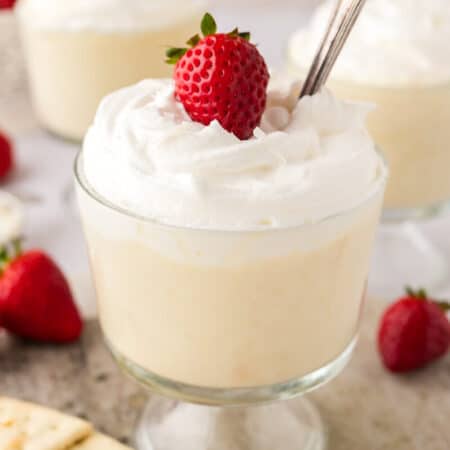 Cracker pudding in a parfait dish with a spoon.