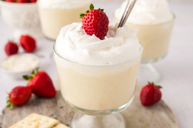 Cracker pudding in a parfait dish with a spoon.