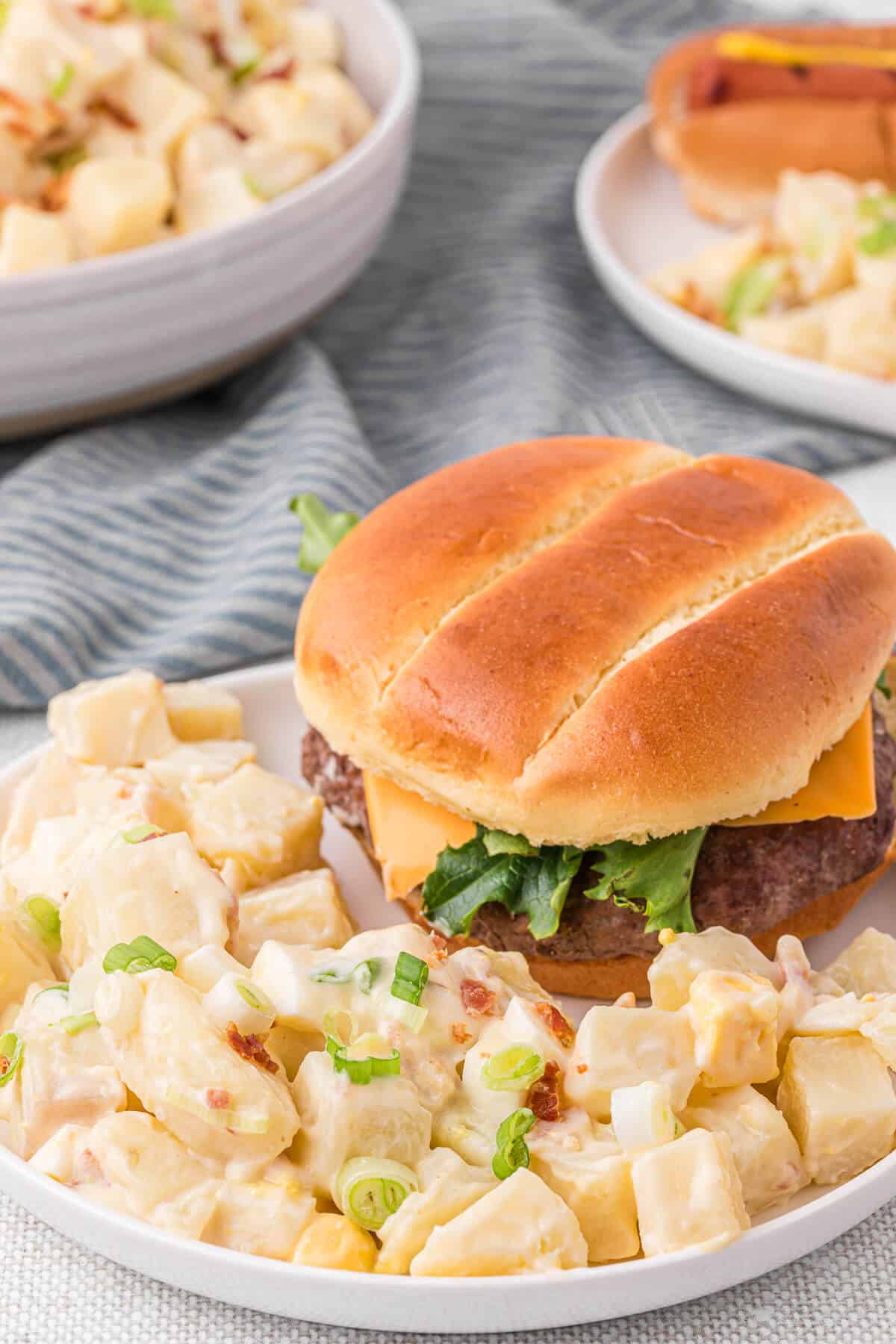 Dutch potato salad on a plate with a hamburger.