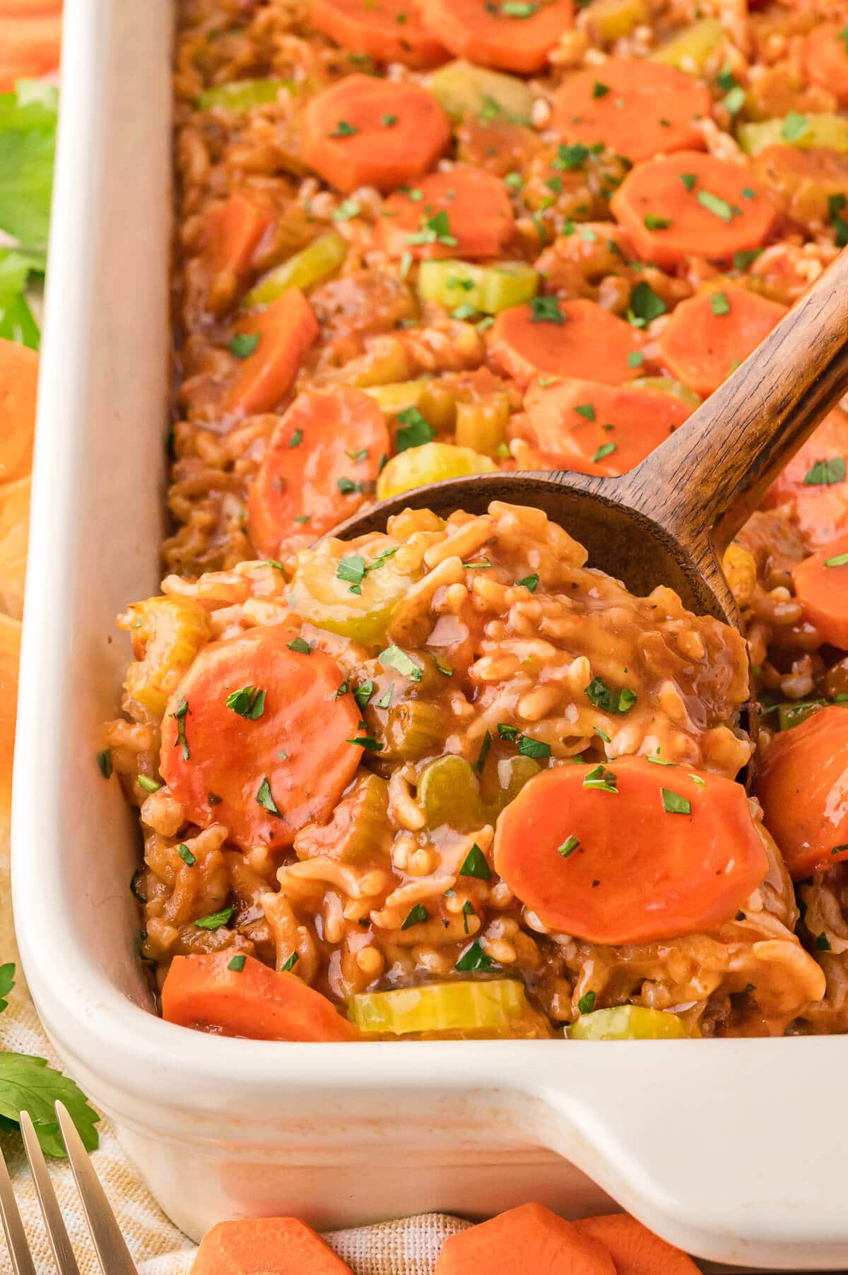 Shipwreck Casserole in a pan with a wooden spoon.