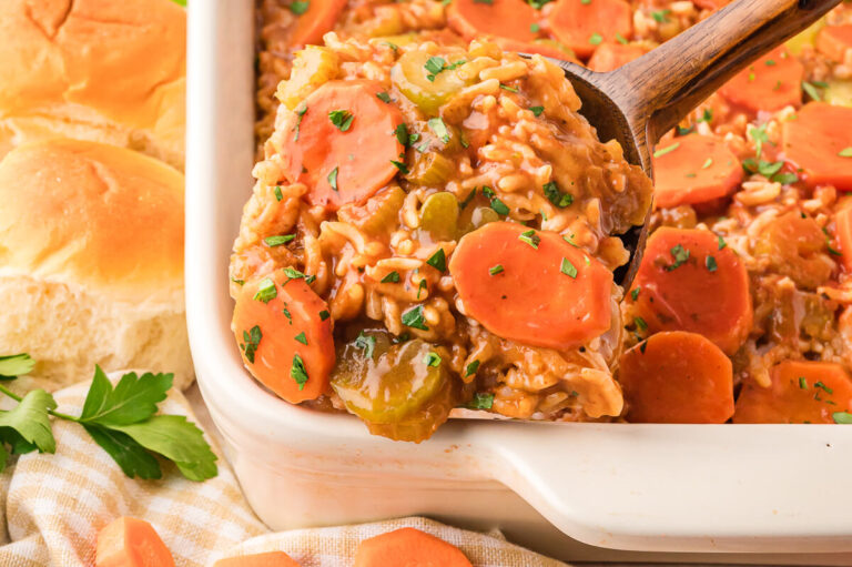 The recipe in a pan and a wooden spoon serving a scoop of it.