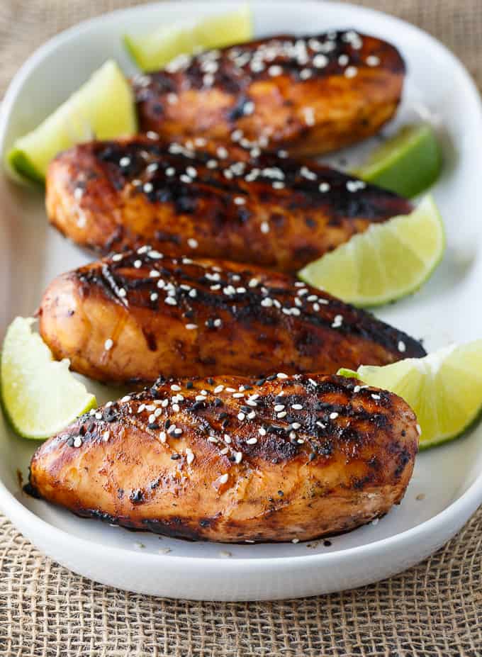 Honey Sriracha Chicken - Packed full of sweet and spicy flavour. The marinade is only four ingredients and can be whipped up in a matter of minutes. Grilled to perfection, this delicious summer dish is wonderful at backyard BBQs.