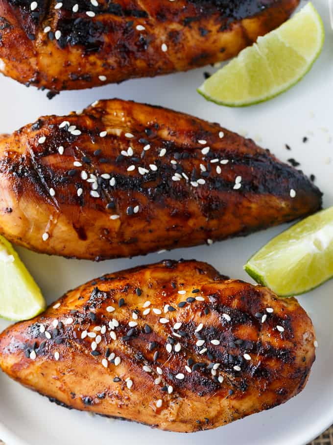 Honey Sriracha Chicken - Packed full of sweet and spicy flavour. The marinade is only four ingredients and can be whipped up in a matter of minutes. Grilled to perfection, this delicious summer dish is wonderful at backyard BBQs.