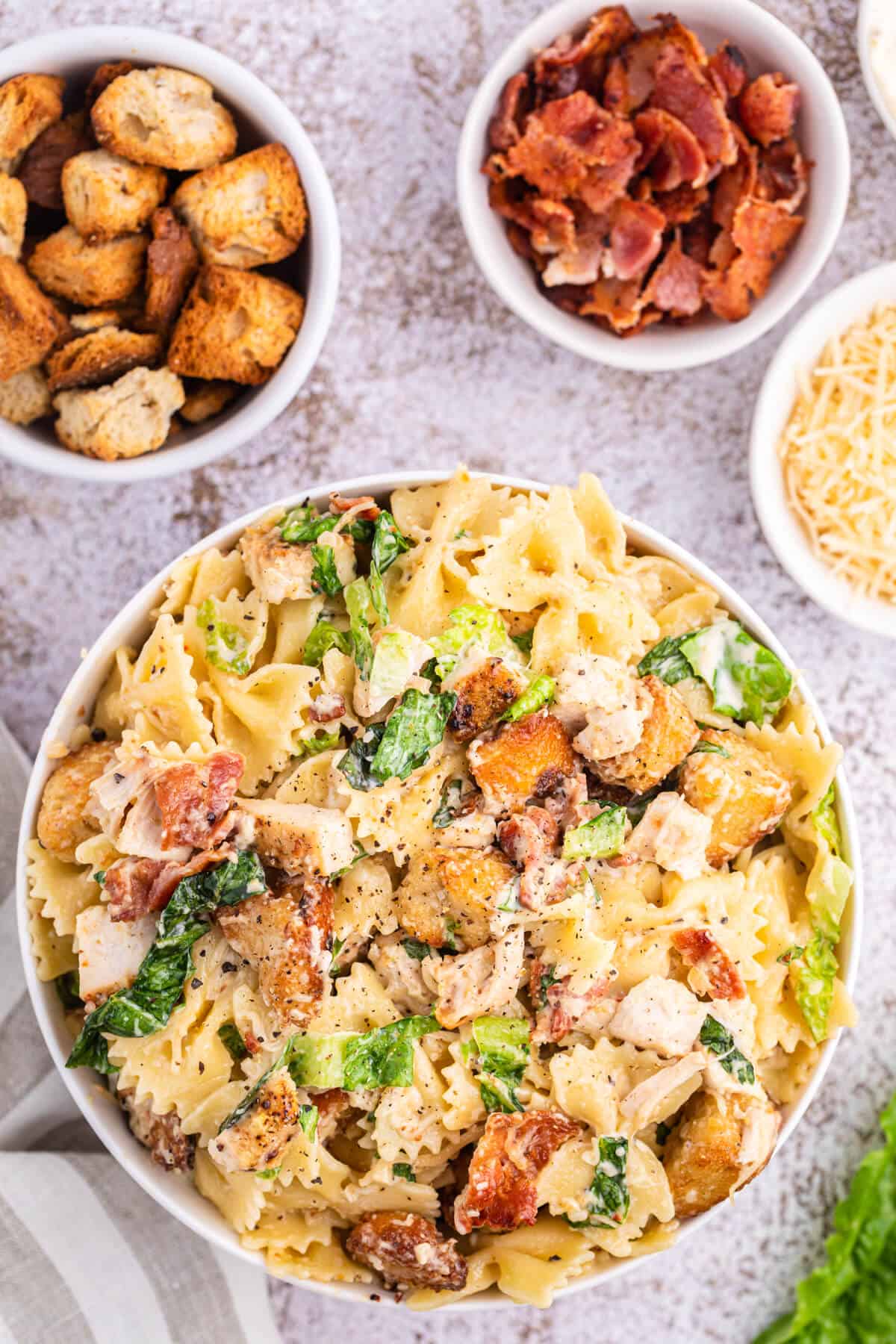 A bowl of chicken caesar pasta salad.