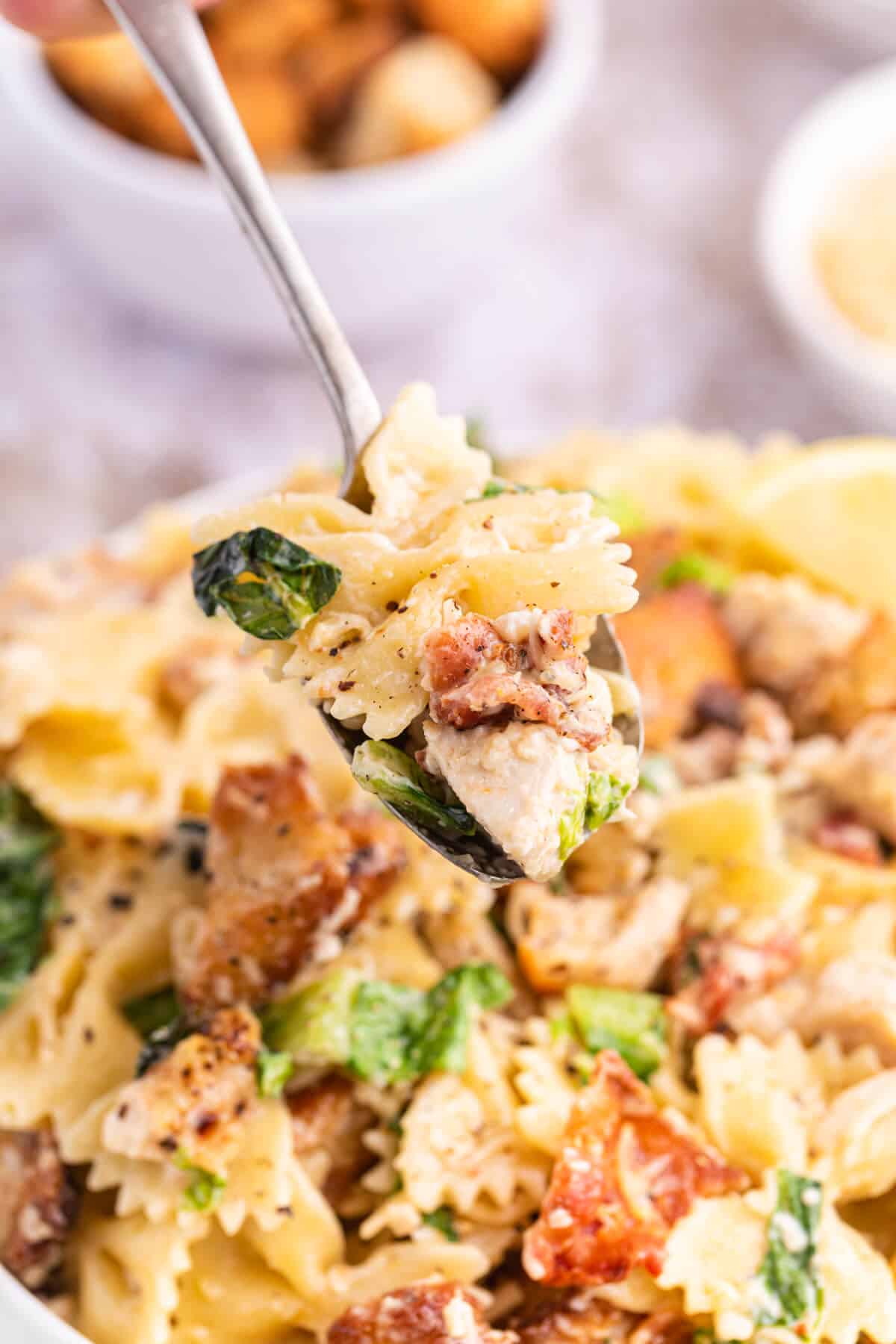 Chicken Caesar Pasta Salad on a spoon.