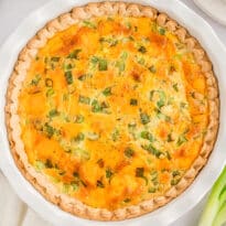 Hamburger quiche in a white pie pan.