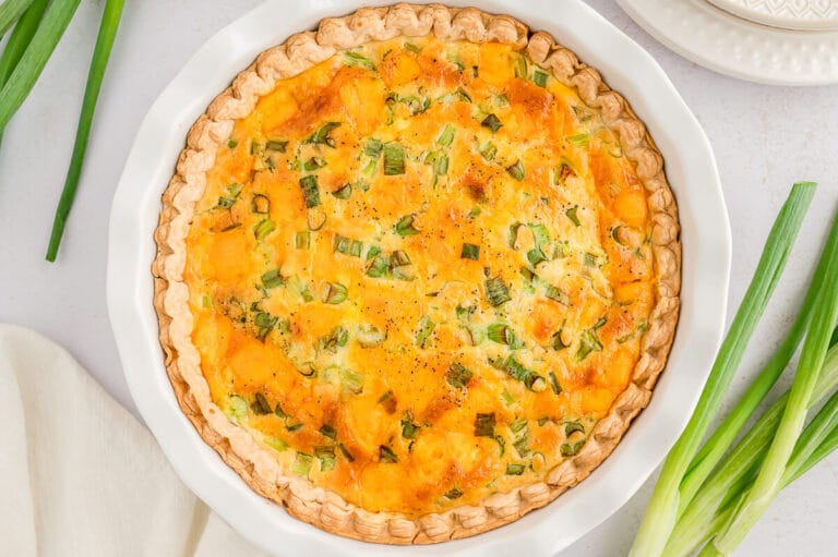 Hamburger quiche in a white pie pan.