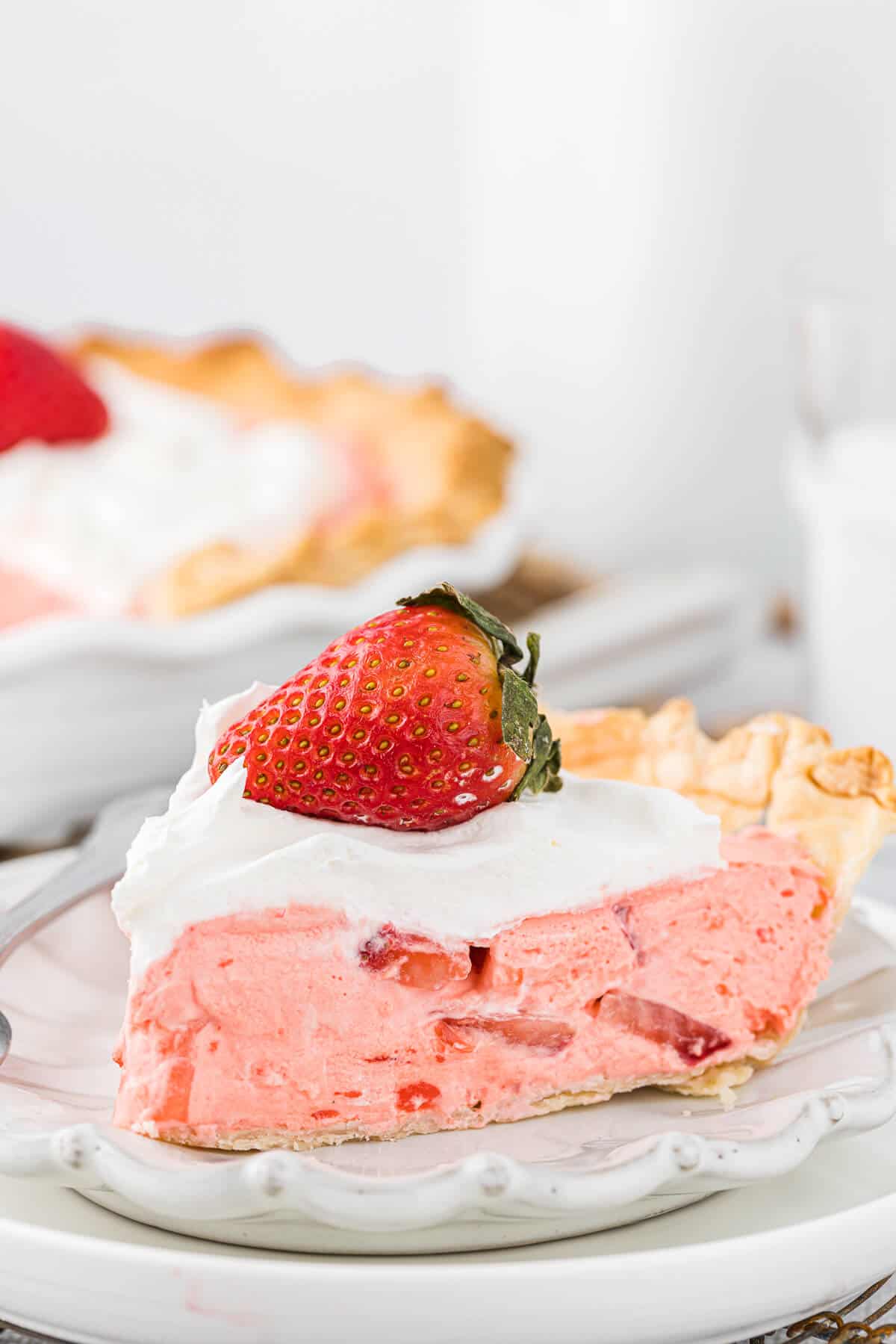 A slice of strawberry cream pie on a plate.
