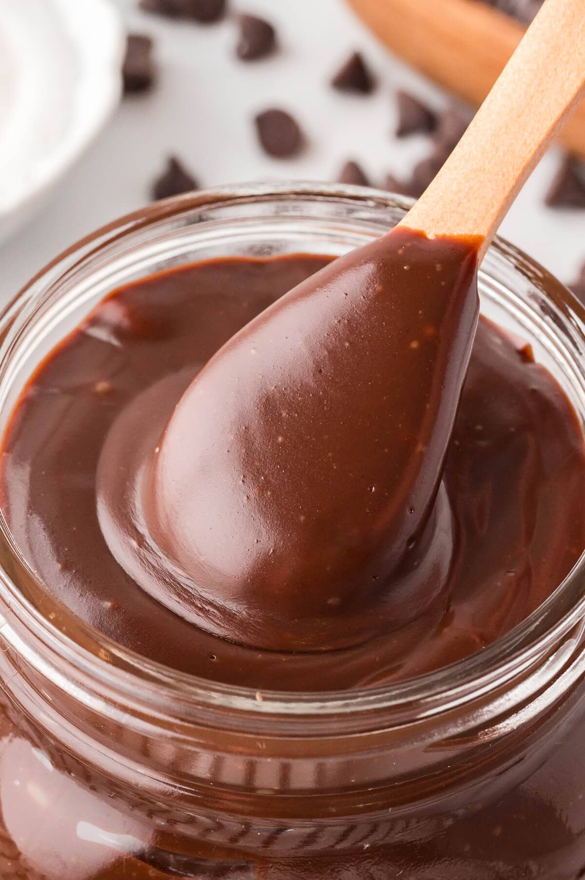 A wooden spoon in a jar of the recipe.