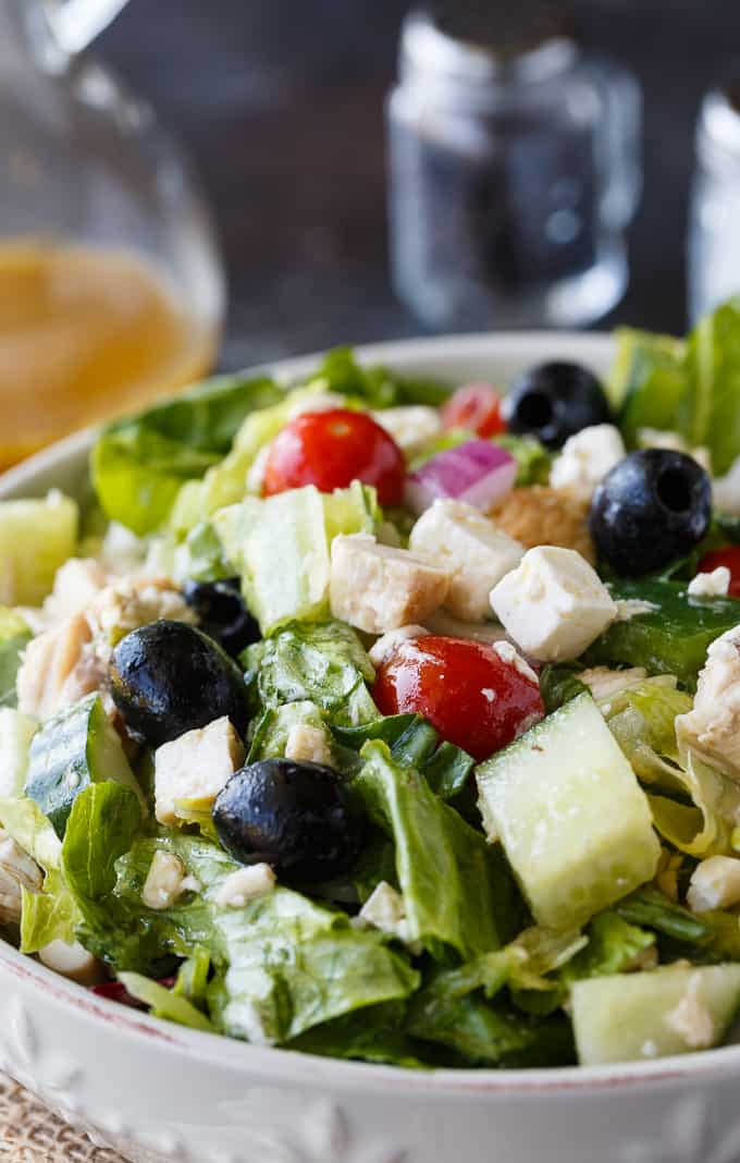 Greek Chicken Salad - This delicious salad is a meal on its own! It's loaded with chicken, fresh veggies, black olives, feta cheese and a Greek vinaigrette.