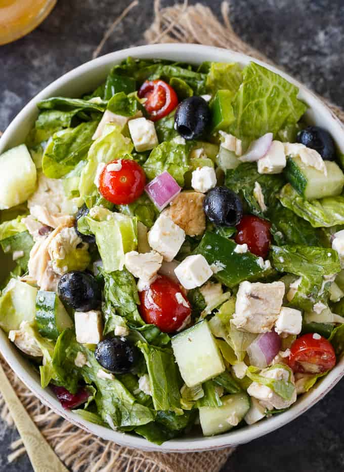 Greek Chicken Salad - This delicious salad is a meal on its own! It's loaded with chicken, fresh veggies, black olives, feta cheese and a Greek vinaigrette.