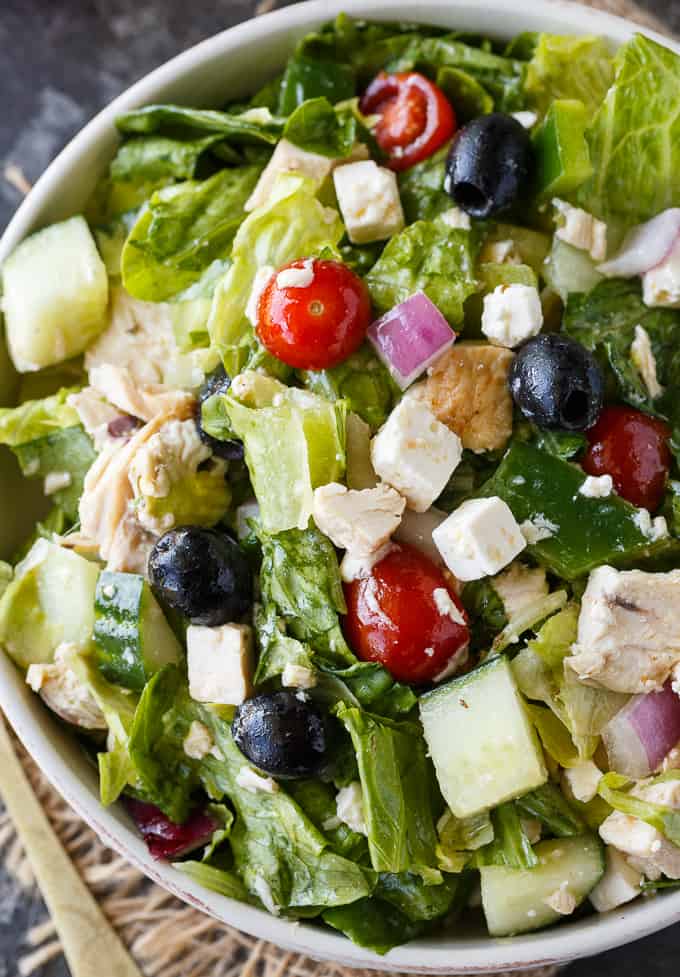 Greek Chicken Salad - This delicious salad is a meal on its own! It's loaded with chicken, fresh veggies, black olives, feta cheese and a Greek vinaigrette.