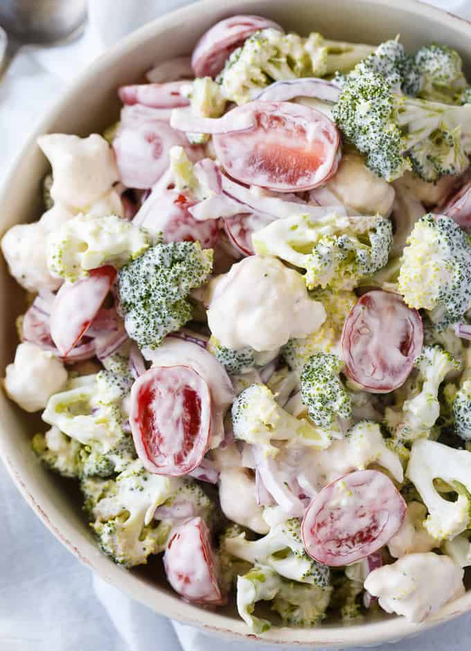 Christmas Salad - Contains all the colors of Christmas! This fresh, bright salad is made with broccoli, cauliflower, red onion and cherry tomatoes mixed with a creamy dressing.