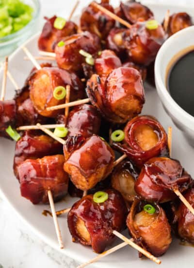 Bacon wrapped water chestnuts on a serving platter.