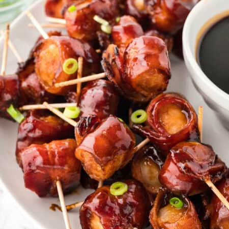 Bacon wrapped water chestnuts on a serving platter.