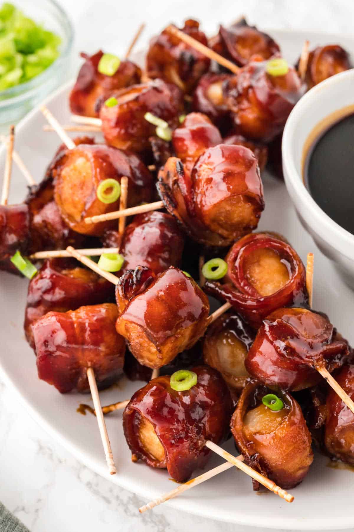 Bacon wrapped water chestnuts on a serving platter.