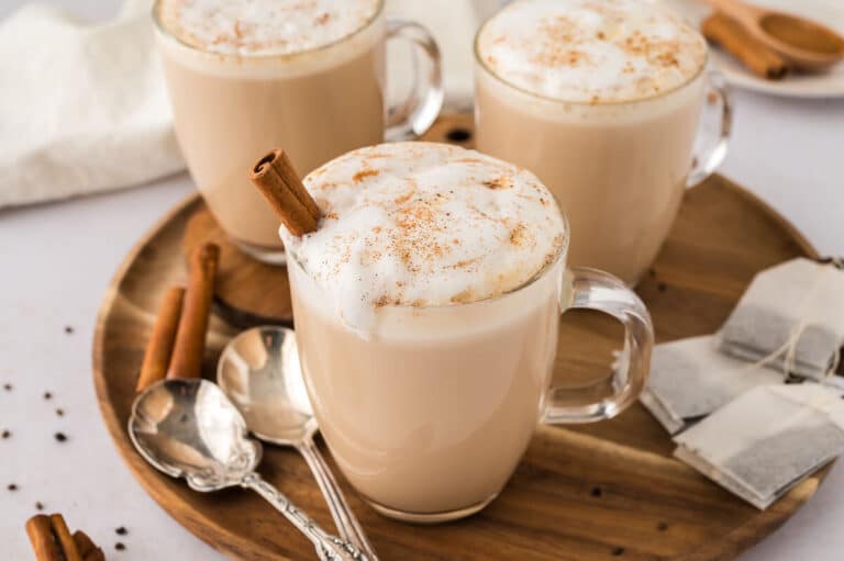 Slow cooker chai latte in a glass mug.