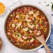 Texas beef skillet in a pan with a wooden serving spoon.