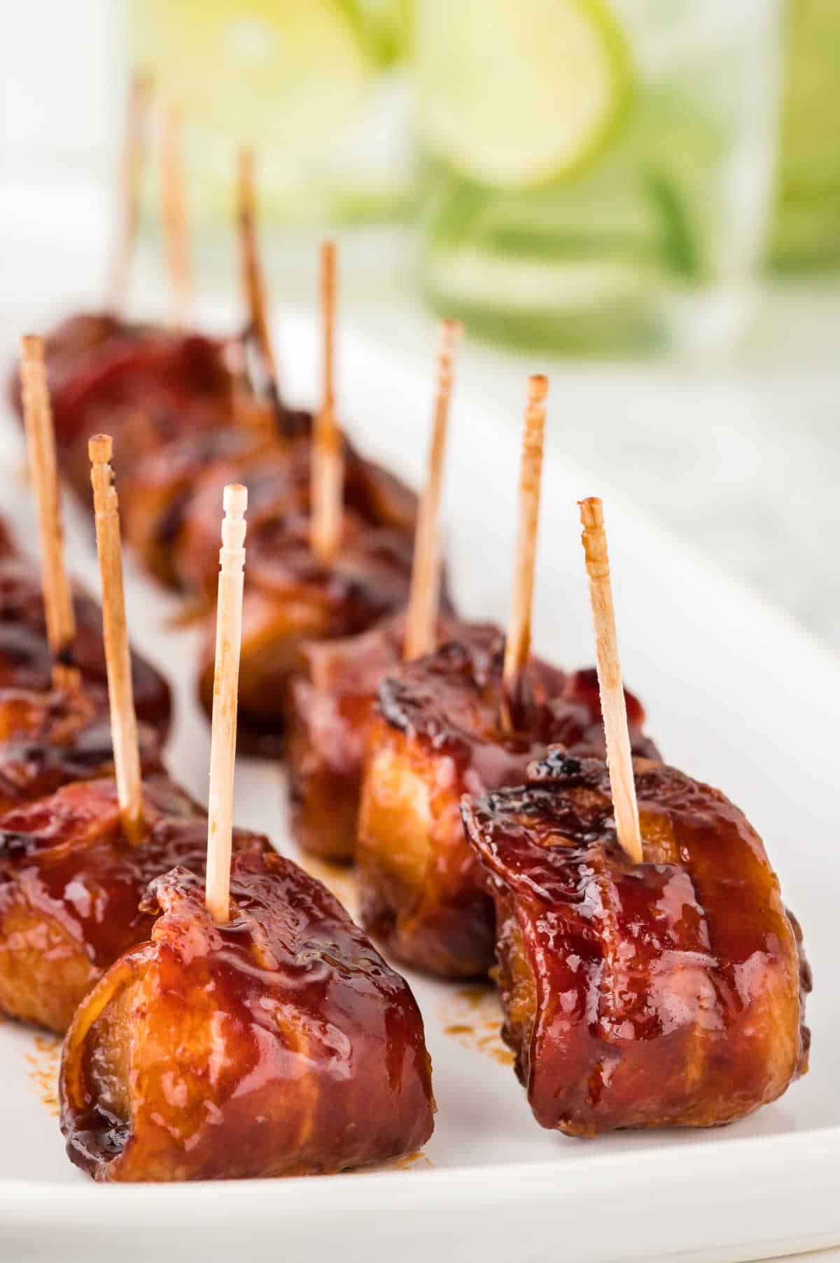 Bacon wrapped water chestnuts on a platter.