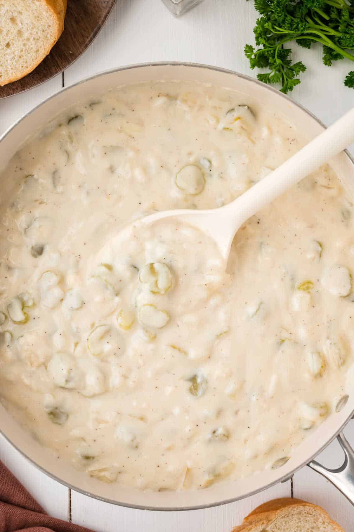 A pot of cream of celery with a serving spoon.