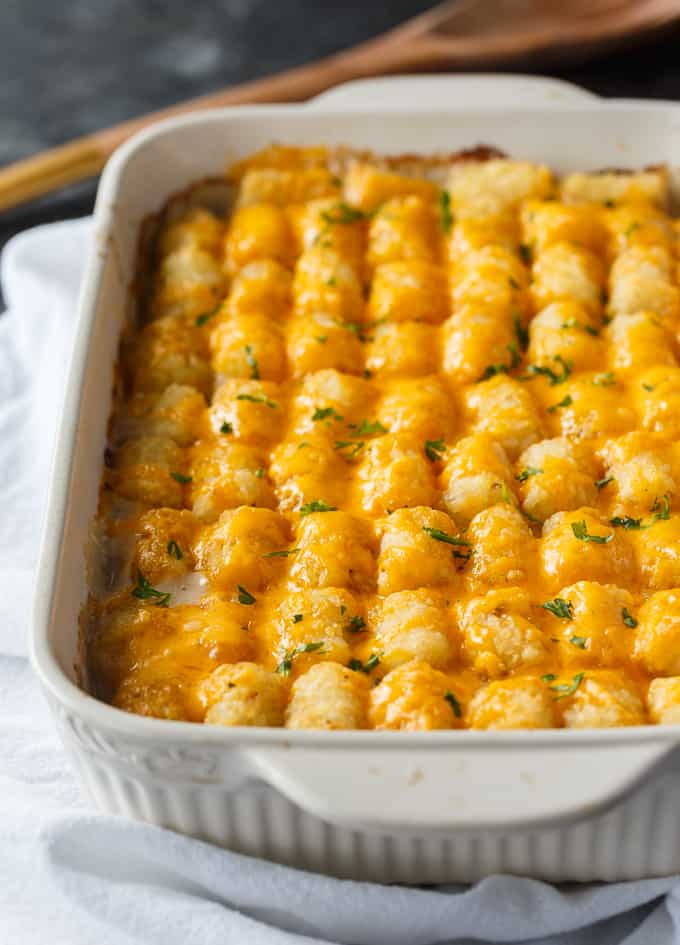 Tater Tot Casserole - A classic comfort food casserole your family will love! It has a layer of ground beef mixed with a creamy veggie sauce and topped with crispy Tater Tots and melted cheddar cheese.