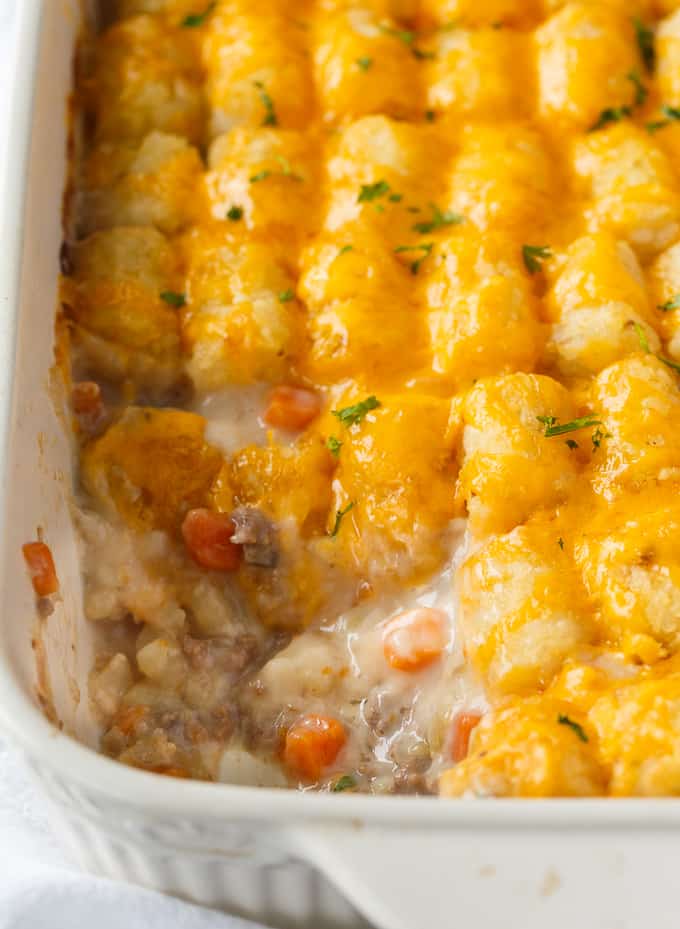 Tater Tot Casserole - A classic comfort food casserole your family will love! It has a layer of ground beef mixed with a creamy veggie sauce and topped with crispy Tater Tots and melted cheddar cheese.
