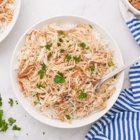 Brown sugar chicken in a bowl with a fork.