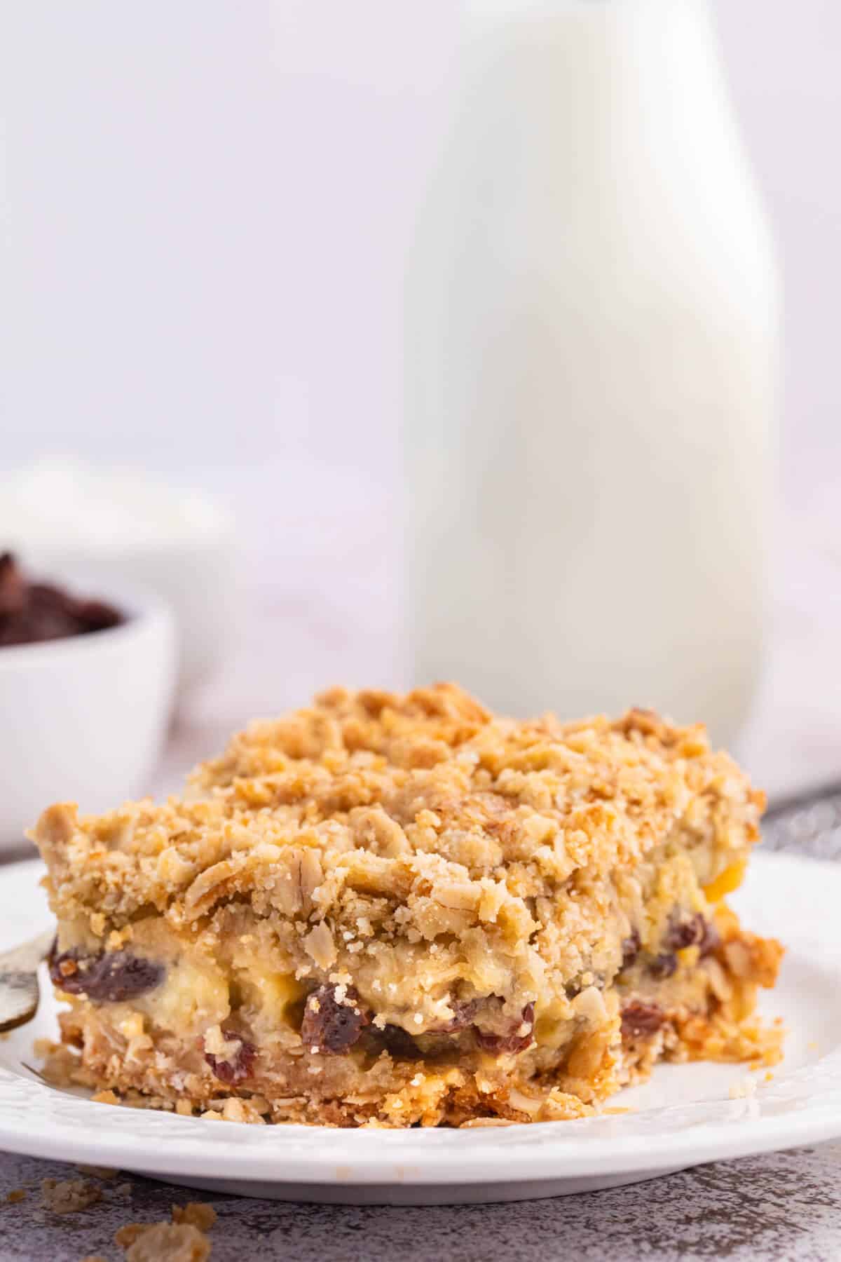 A sour cream raisin bar on a plate.