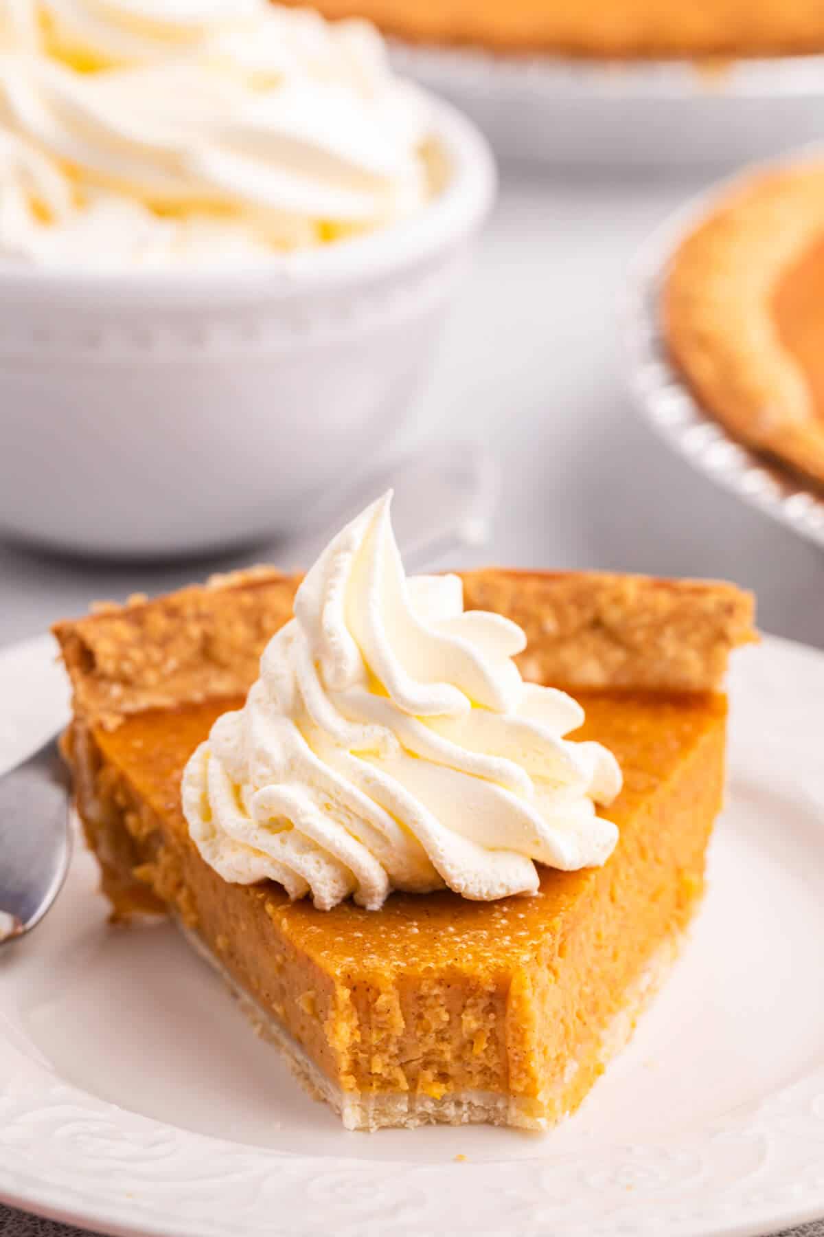 Sweet potato pie slice with a bite off the end.