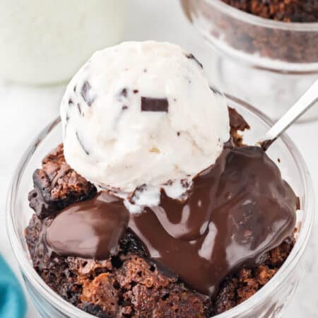 Hot Fudge Pudding Cake in a bowl topped with vanilla ice cream.