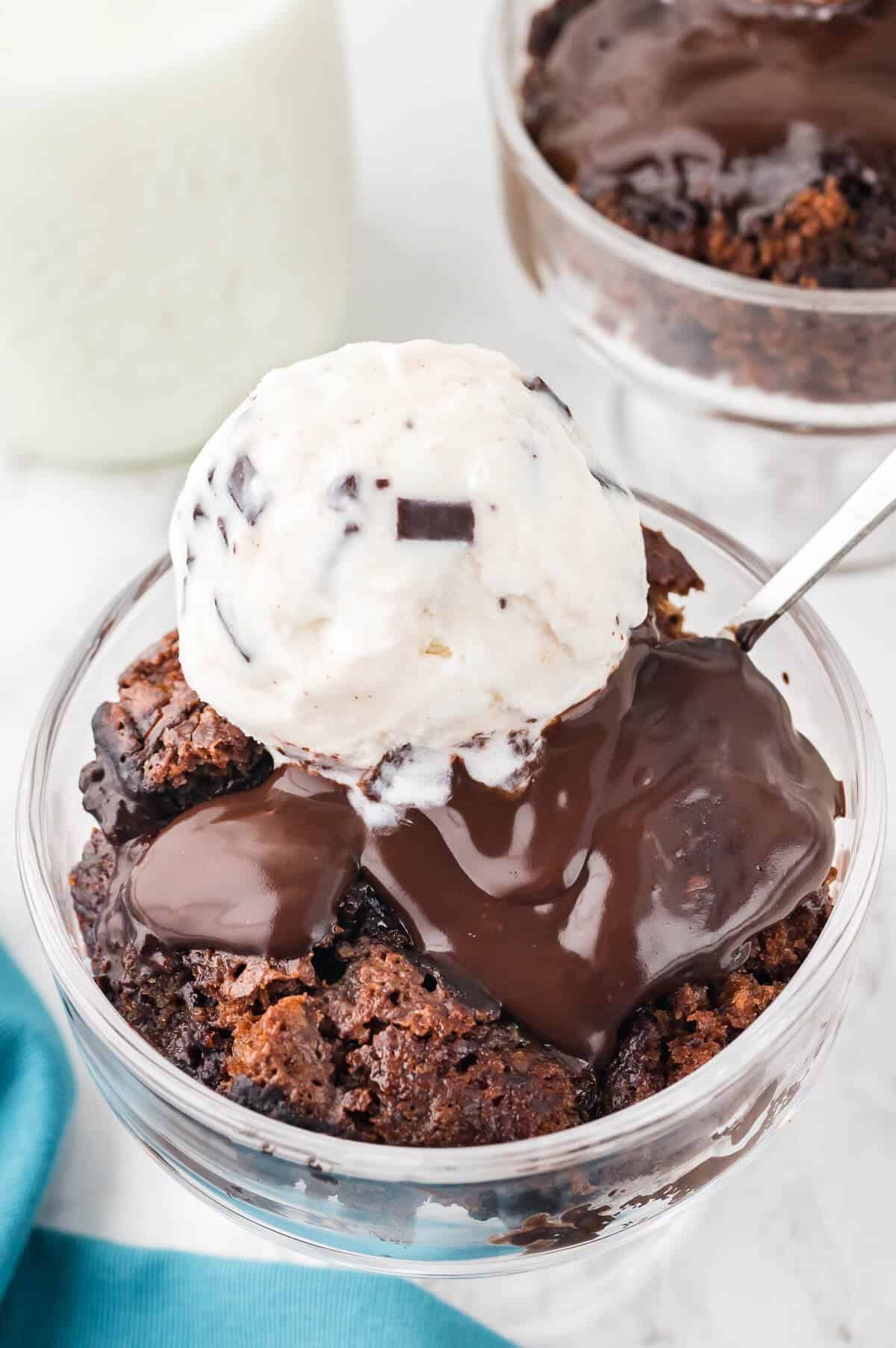 Hot Fudge Pudding Cake in a bowl topped with vanilla ice cream.