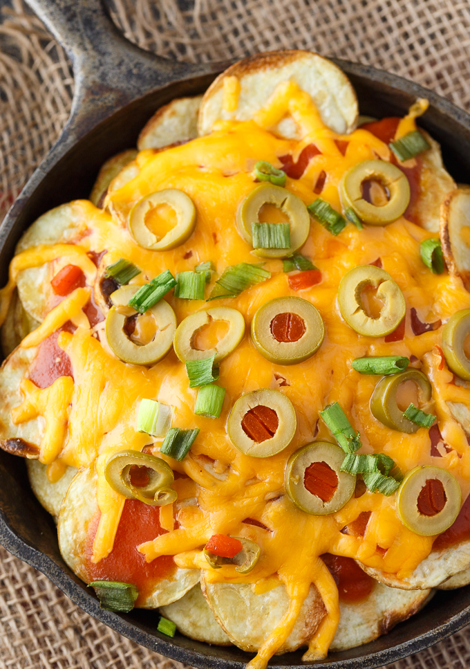 Potato Nachos - Crispy, flavorful potatoes loaded with taco sauce, green olives, green onions and lots of melty cheddar cheese. The perfect appetizer!