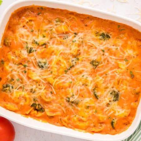 Tortellini casserole in a white casserole dish.