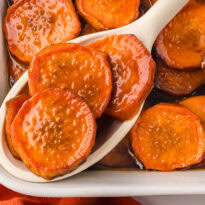 The recipe on a serving spoon in a casserole dish.