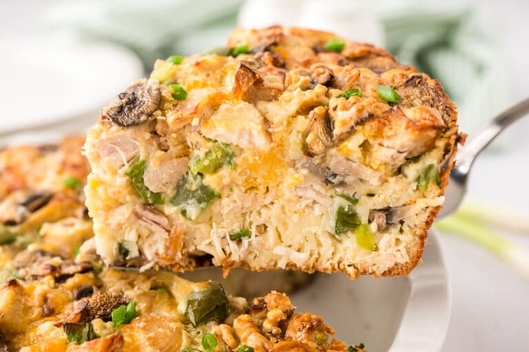 A slice of impossible chicken pie on a serving spatula.