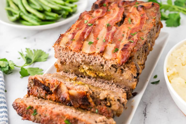 Sunday meatloaf on a platter with slices cut off the end.