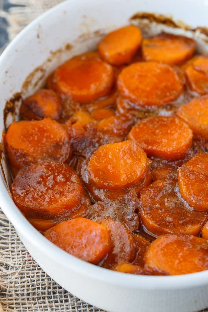 Candied Sweet Potatoes - An easy side dish recipe that tastes like a dessert. Tender sweet potato rounds are covered in a rich, buttery glaze.