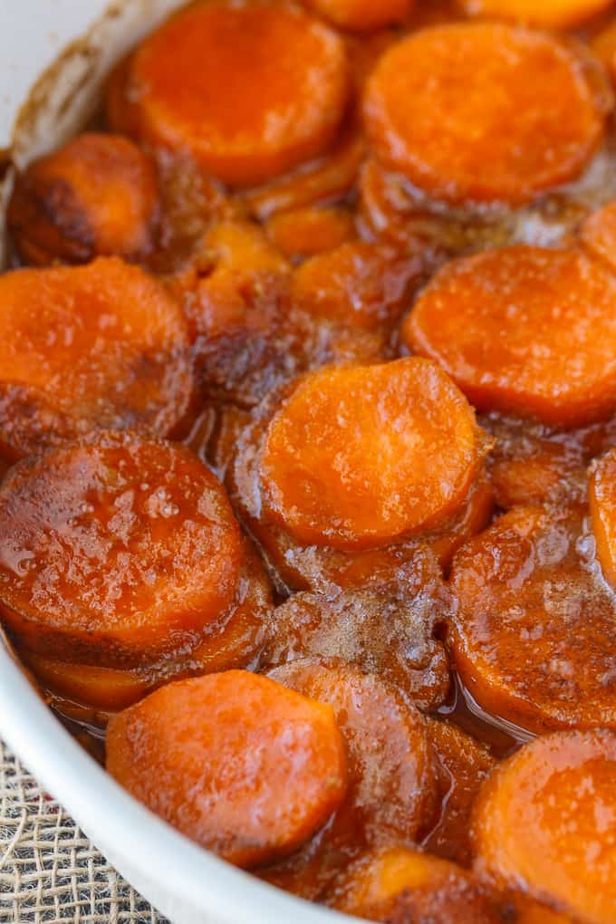 Candied Sweet Potatoes - An easy side dish recipe that tastes like a dessert. Tender sweet potato rounds are covered in a rich, buttery glaze.