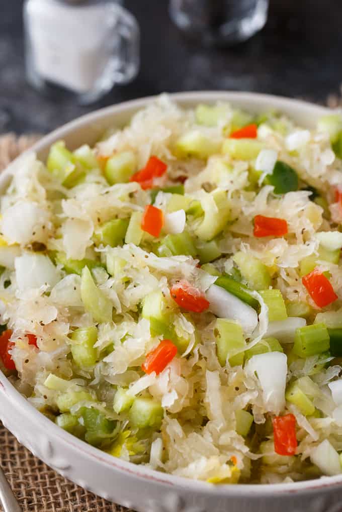 Sauerkraut Salad - Tangy and sweet! This delicious salad recipe has crisp veggies, sauerkraut tossed in a sweet dressing. Delish!