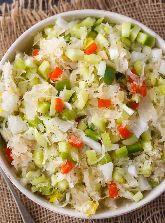 Sauerkraut Salad - Tangy and sweet! This delicious salad recipe has crisp veggies, sauerkraut tossed in a sweet dressing. Delish!