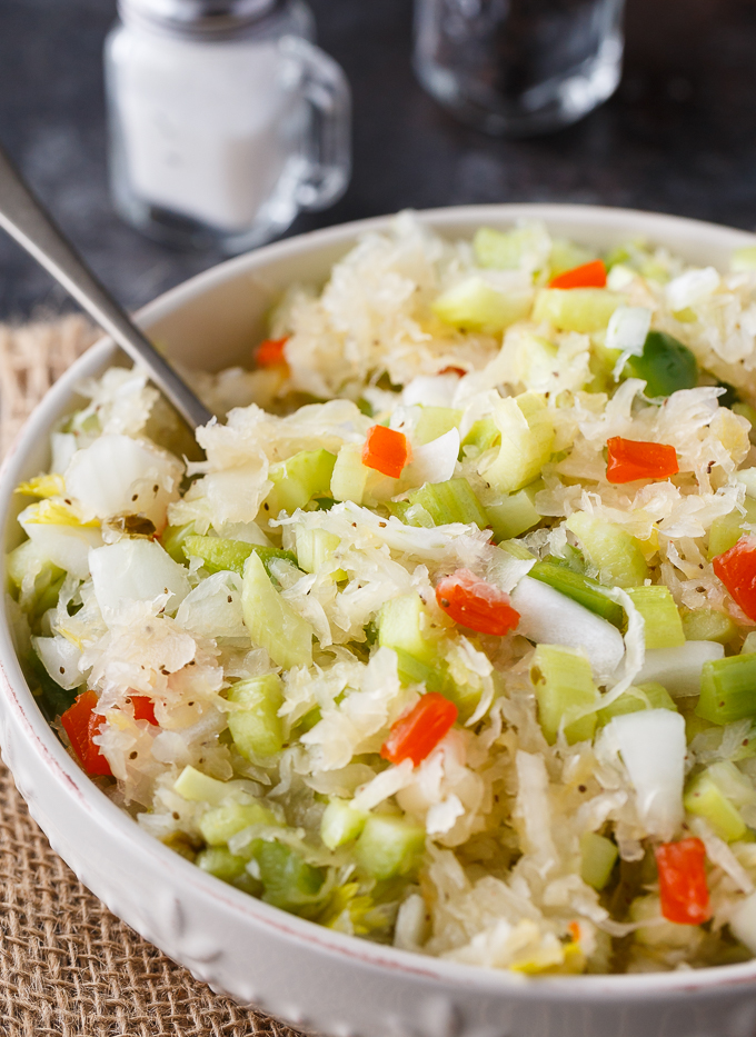 Sauerkraut Salad - Tangy and sweet! This delicious salad recipe has crisp veggies, sauerkraut tossed in a sweet dressing. Delish!