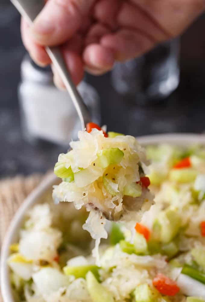 Sauerkraut Salad - Tangy and sweet! This delicious salad recipe has crisp veggies, sauerkraut tossed in a sweet dressing. Delish!