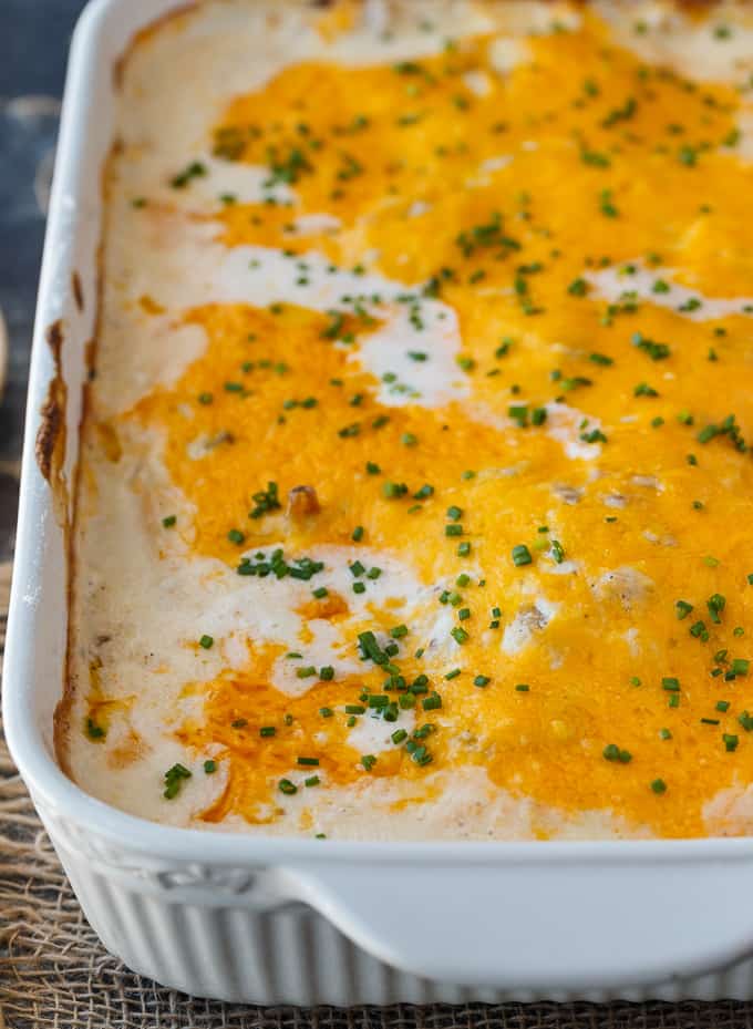 Sour Cream Chicken Bake - Creamy, cheesy comfort food. This easy chicken casserole is smothered in a rich sour cream sauce and loads of cheddar cheese.