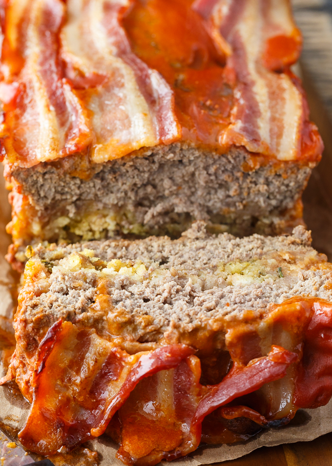 Sunday Meatloaf - A delicious family recipe! This easy meatloaf has a flavorful stuffing filling and is topped with a mouthwatering tomato sauce and bacon.