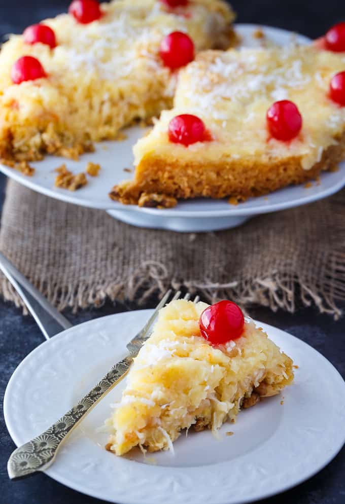 Fool's Cake - A simple, fool-proof cake everyone loves! This yummy dessert has layers of walnuts, yellow cake, coconut and pineapple. Perfect for potlucks!