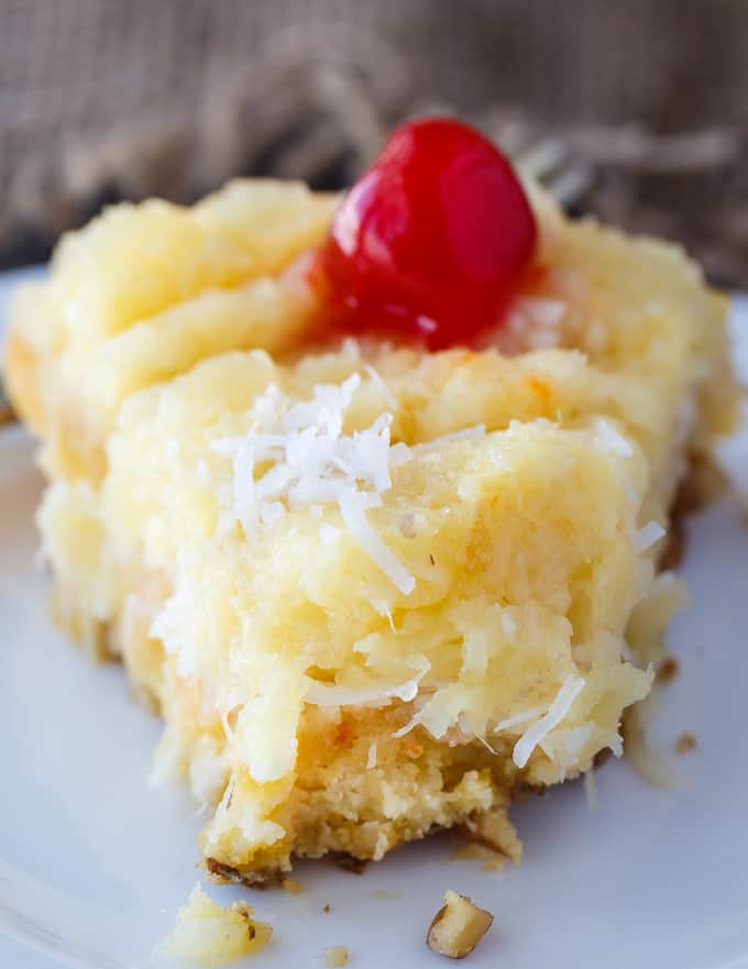 Fool's Cake - A simple, fool-proof cake everyone loves! This yummy dessert has layers of walnuts, yellow cake, coconut and pineapple. Perfect for potlucks!