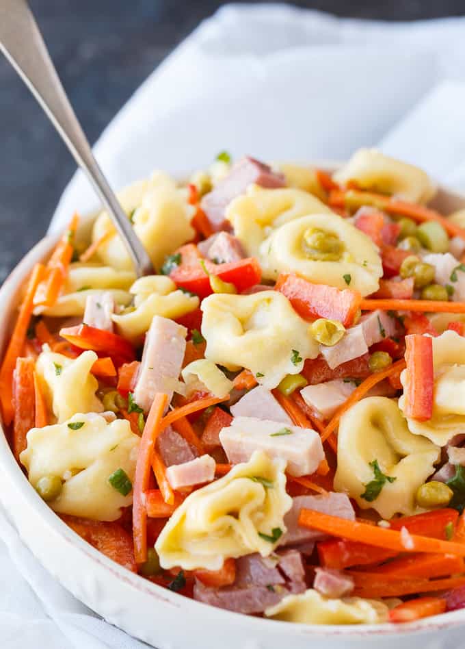 Tortellini Salad - This colorful pasta salad is packed full of flavor with tender pieces of ham, cheese tortellini and fresh, crisp veggies. Serve it at spring and summer parties!